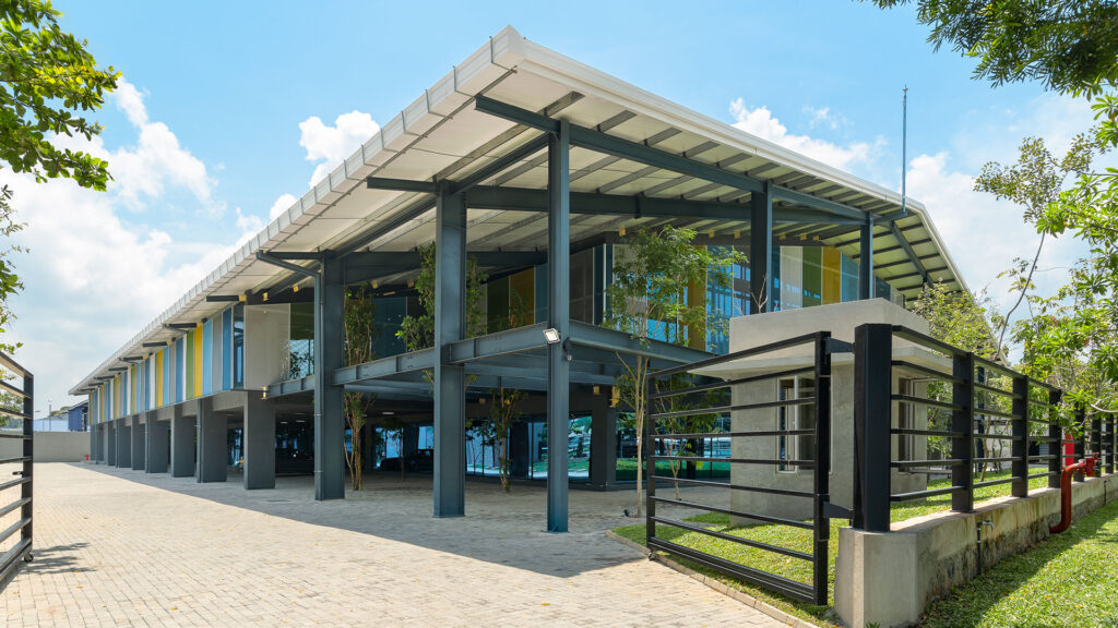 Modern office building exterior with glass windows and colorful panels at Star Garment